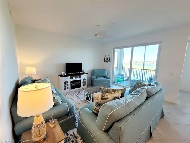 Tiled living room featuring ceiling fan