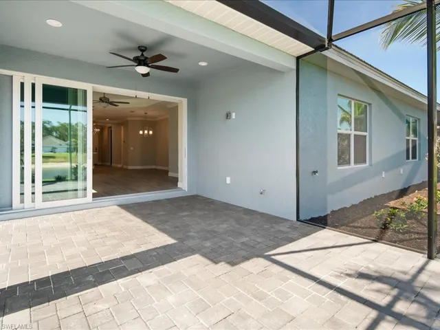 Screened-in paver patio with a ceiling fan, recessed lighting, and sliding glass door access to the interior