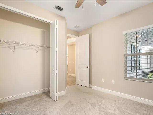 Neutral-toned walls complement plush carpeting