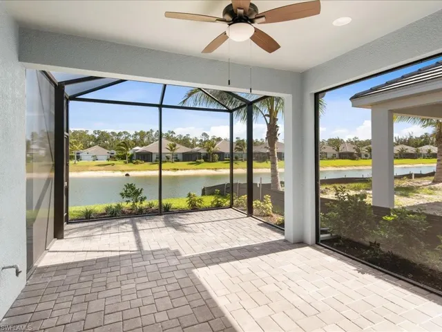 Screened lanai featuring paver flooring, ceiling fan, and recessed lighting
