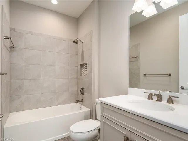 Neutral-toned vanity with an integrated sink and brushed nickel faucet