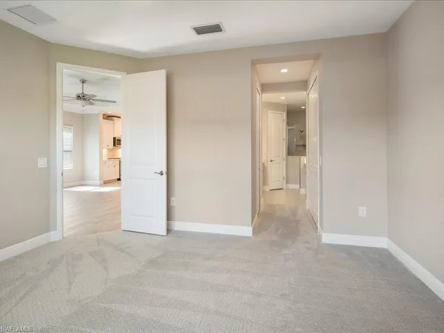 Plush carpeting, neutral wall colors, recessed lighting, and white interior doors