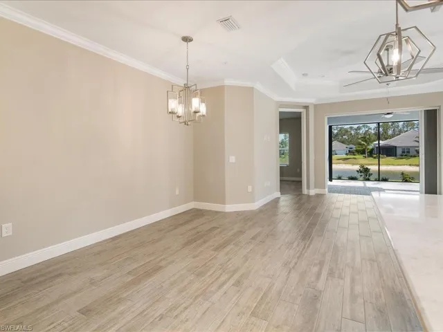 Wood-finish flooring throughout, tray ceiling, and crown molding