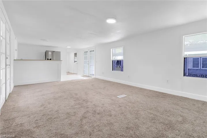 living room featuring carpet and baseboards