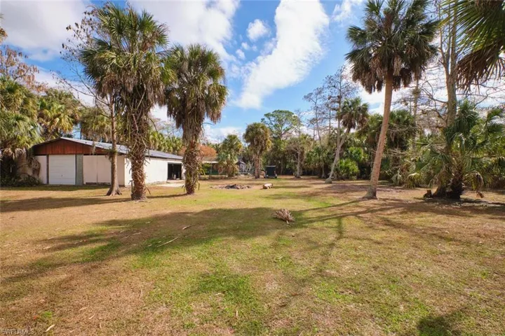 View of grassy yard with detached barn