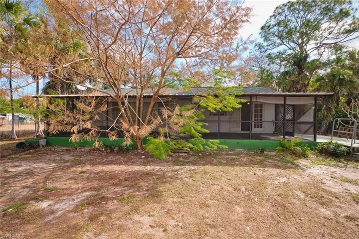 Back of house featuring a screened lanai