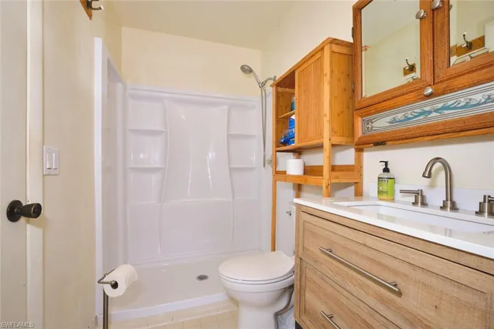 primary bathroom  with vanity, a stall shower,