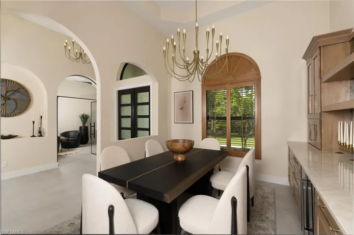 Dining space with vaulted ceiling and brass chandelier