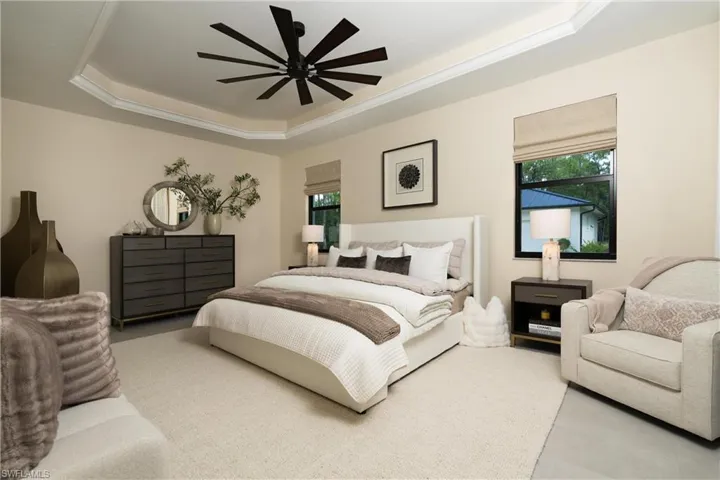 Tray ceiling with crown molding and a multi-blade ceiling fan