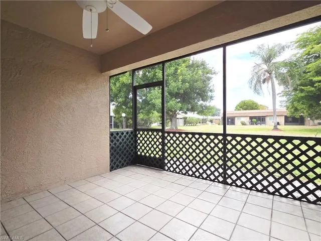 Unfurnished sunroom with ceiling fan