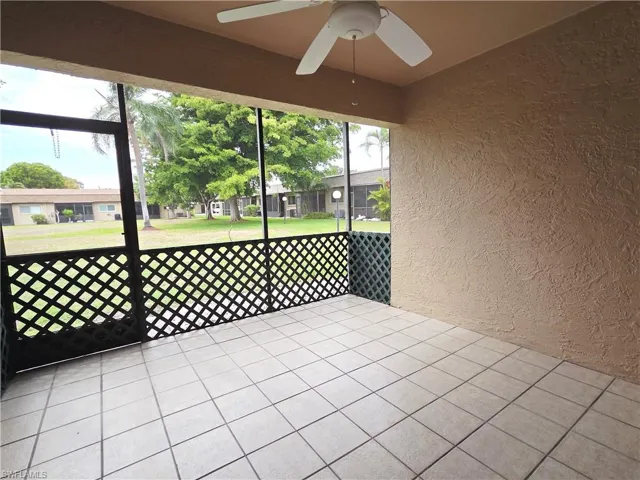 Unfurnished sunroom featuring ceiling fan