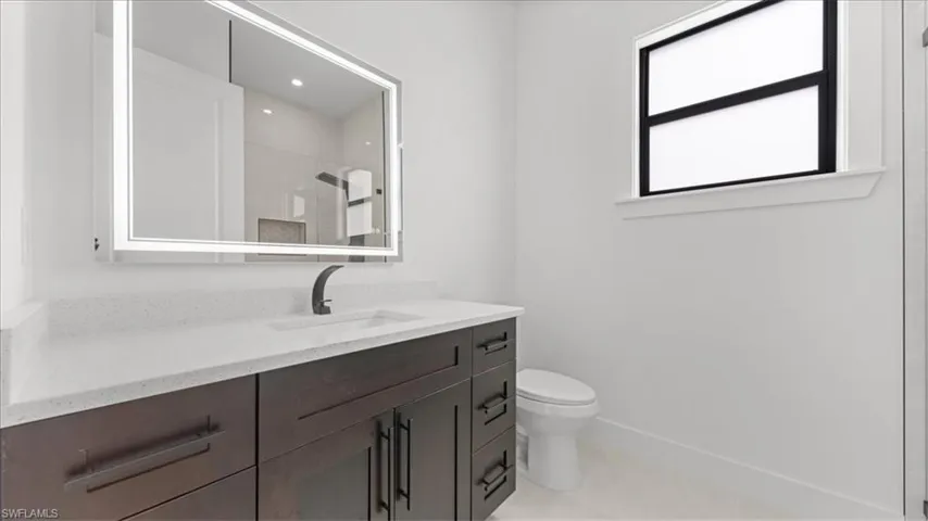 Bathroom featuring vanity and a shower