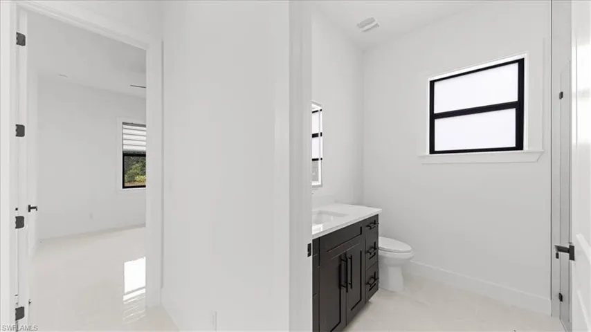 Bathroom featuring vanity and toilet