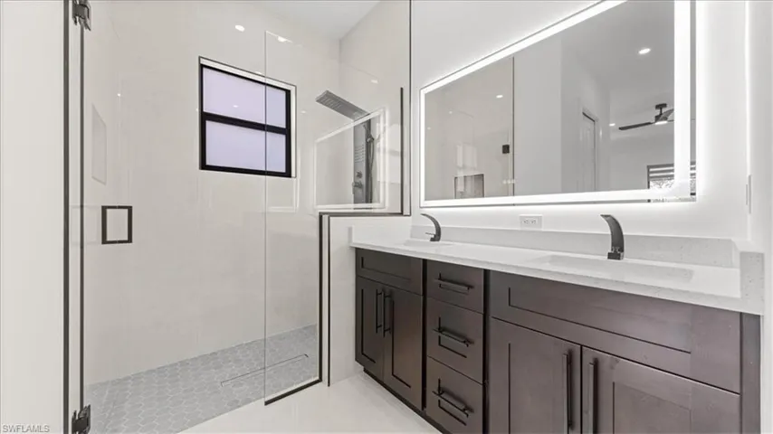 Bathroom with double vanity and a shower stall