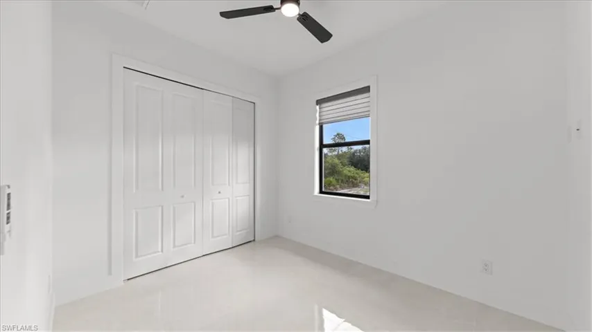 Unfurnished bedroom featuring a closet and a ceiling fan