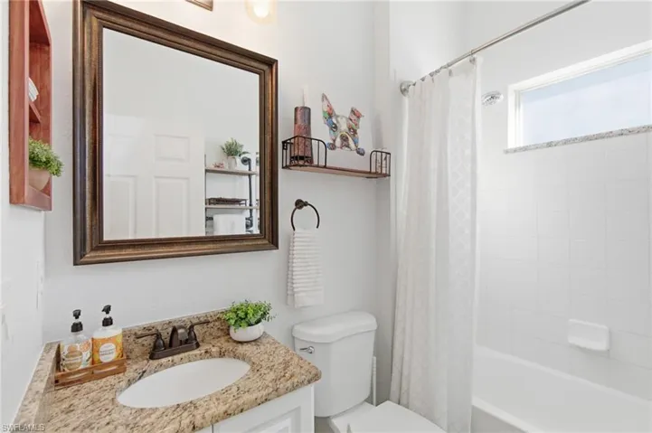 Bathroom with vanity and shower / tub combo with curtain
