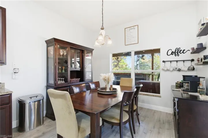 Dining area featuring light wood-style flooring and a chandelier