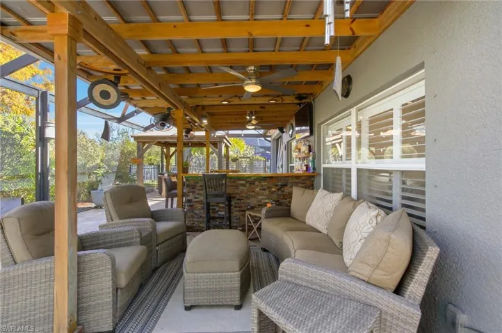 View of patio / terrace with a ceiling fan and an outdoor living space