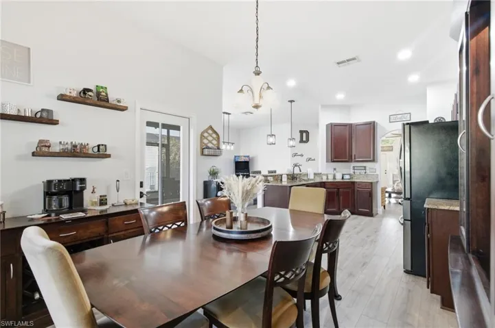 Dining room featuring light wood finished floors, recessed lighting, and a chandelier