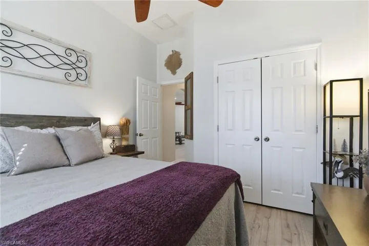 Bedroom featuring light wood-style floors, a closet, and a ceiling fan