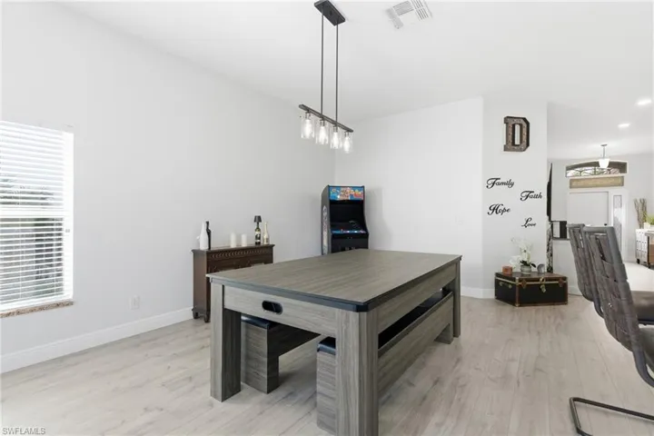 Dining room featuring light wood-type flooring and recessed lighting