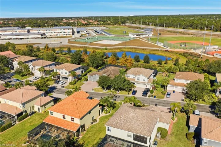 Aerial view of residential area featuring a large body of water