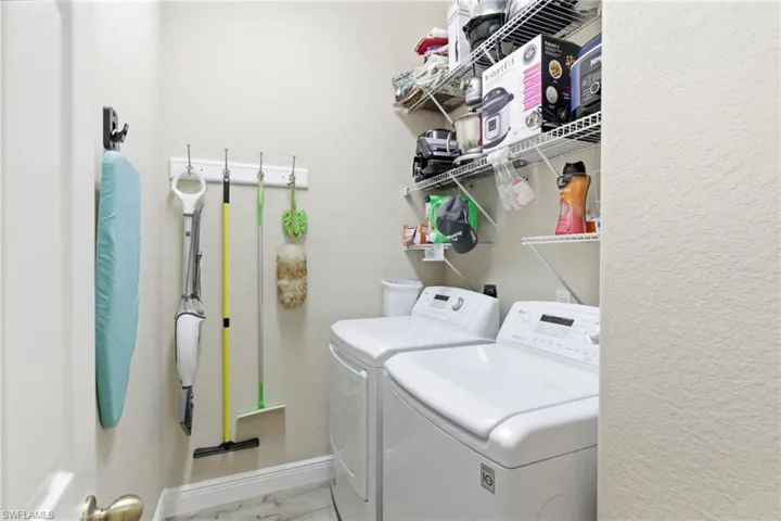 Washroom featuring separate washer and dryer and baseboards