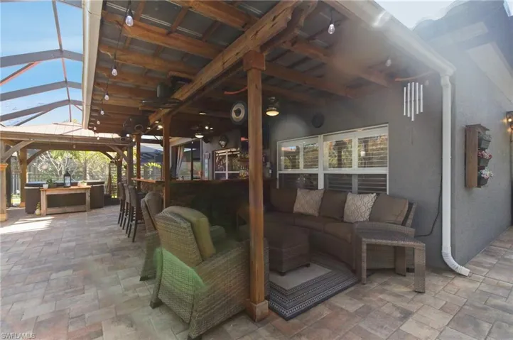View of patio with an outdoor bar, an outdoor living space, and ceiling fan