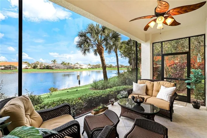 Sunroom / solarium featuring an outdoor living space, ceiling fan, a water view, and a residential view
