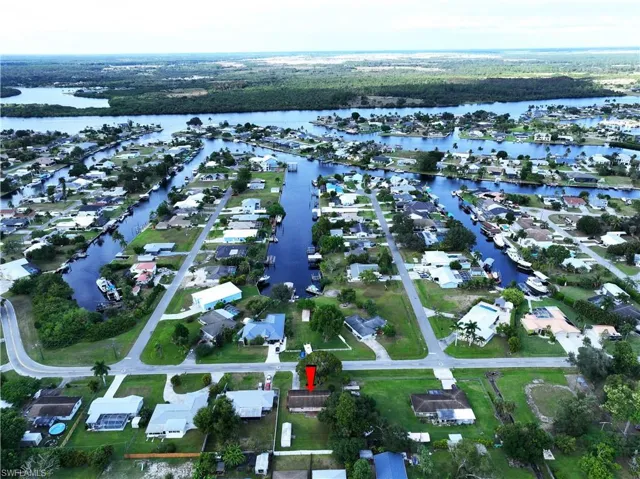 Aerial overview of property's location with a nearby body of water and nearby suburban area