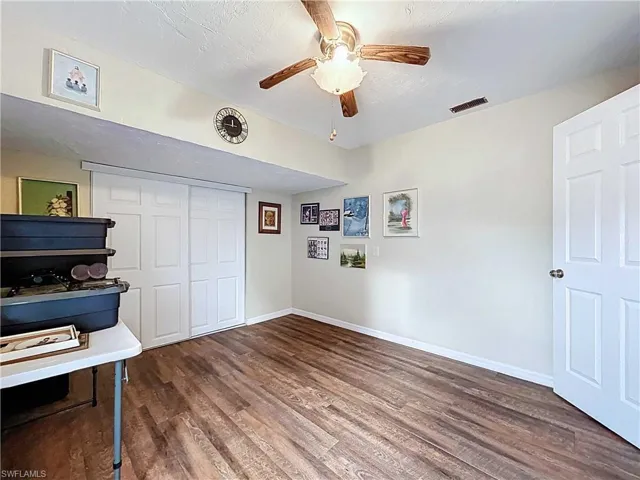 Unfurnished bedroom with a large closet, and a ceiling fan