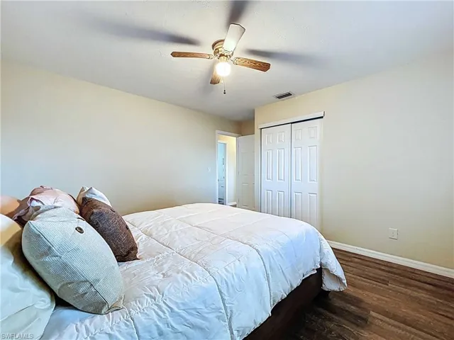 Bedroom with a closet, a ceiling fan, and the vinyl plank flooring.