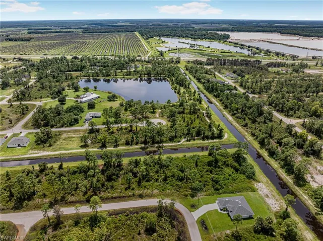 Aerial view featuring a water view and a rural view