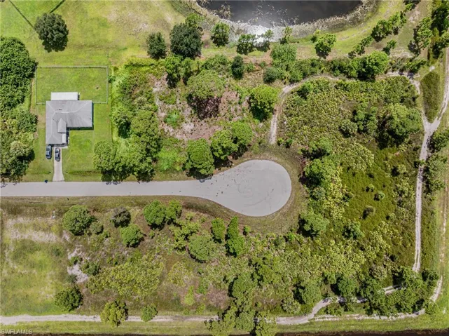 Birds eye view of property with a water view