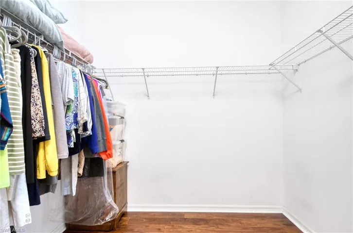 Walk in closet featuring wood finished floors