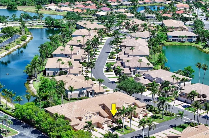 Aerial perspective of suburban area featuring a large body of water