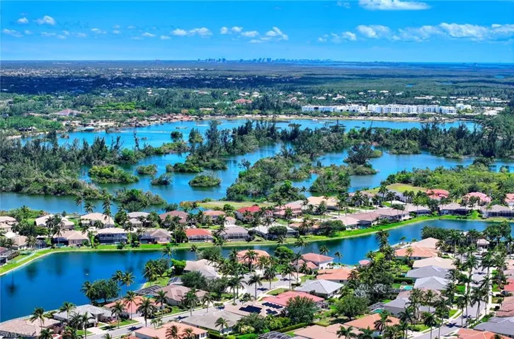 Aerial perspective of suburban area featuring a large body of water