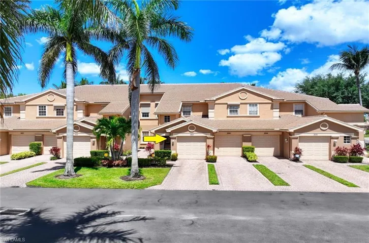Multi unit property with stucco siding, driveway, and a tile roof