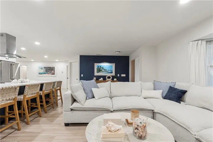 Living area with recessed lighting and light wood-style floors