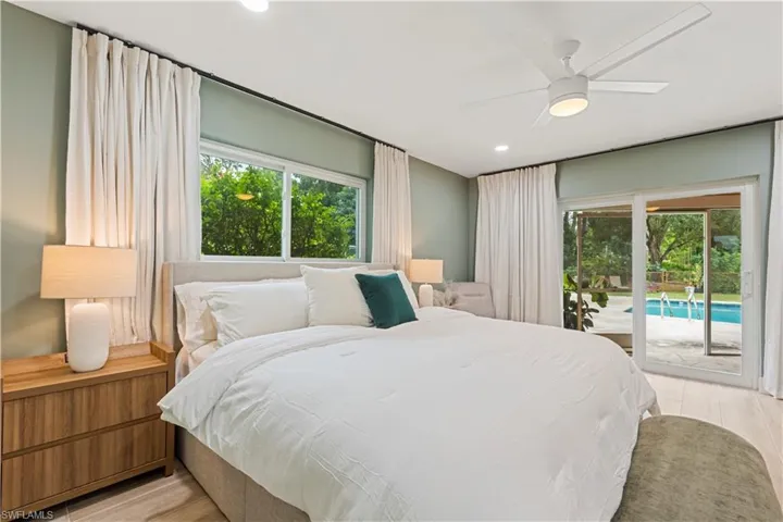 Bedroom featuring multiple windows, light wood-type flooring, access to outside, ceiling fan, and recessed lighting