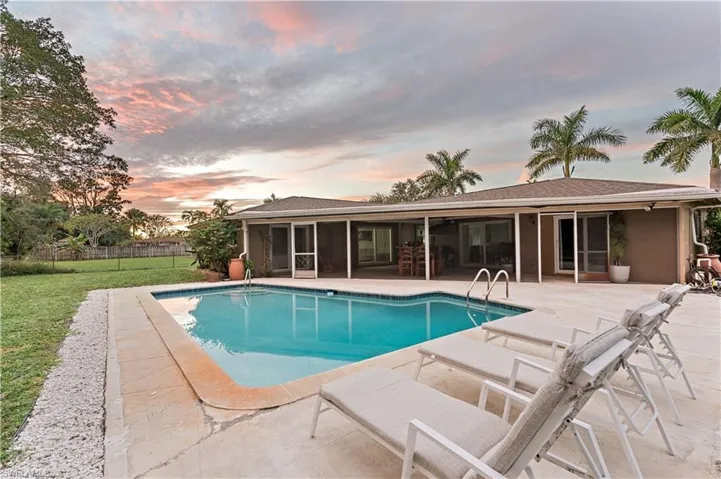 View of pool with a patio area and a sunroom