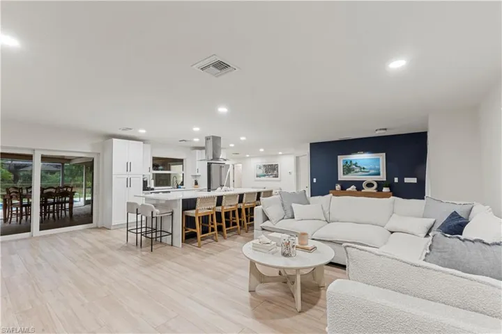 Living area with recessed lighting and light wood finished floors