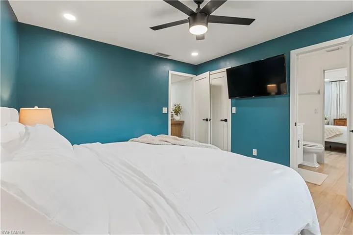 Bedroom featuring light wood-type flooring, a ceiling fan, and recessed lighting