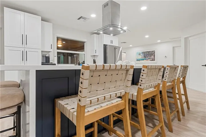 Dining area with light wood-type flooring and recessed lighting