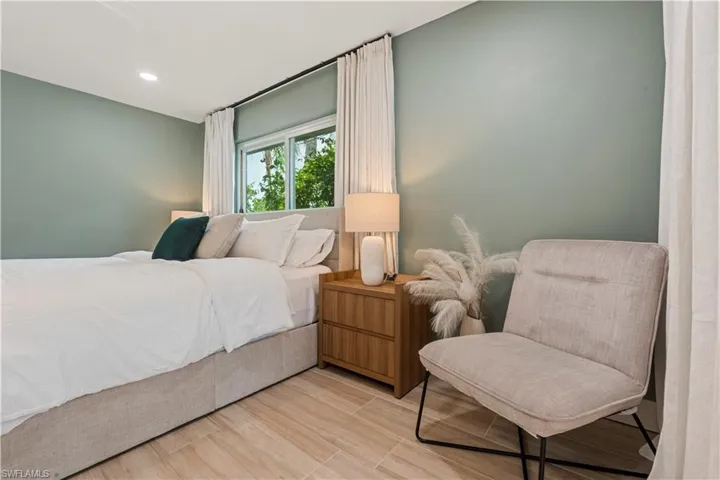 Bedroom with wood finished floors and recessed lighting