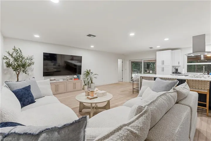 Living area featuring recessed lighting and light wood-style flooring