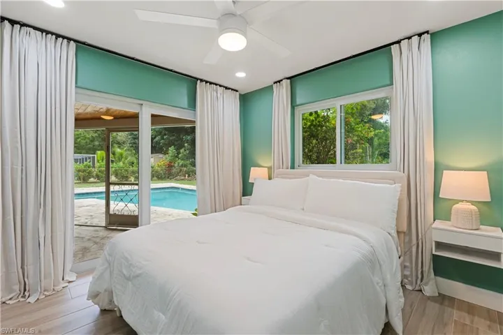 Bedroom featuring access to exterior, wood finished floors, ceiling fan, and recessed lighting