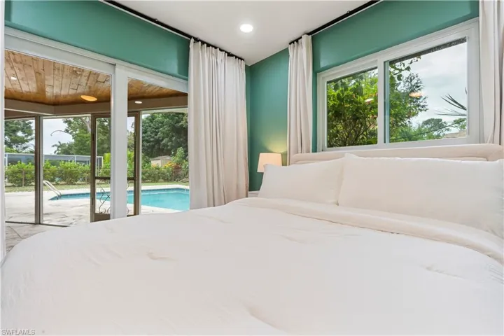 Bedroom featuring multiple windows, access to outside, and recessed lighting