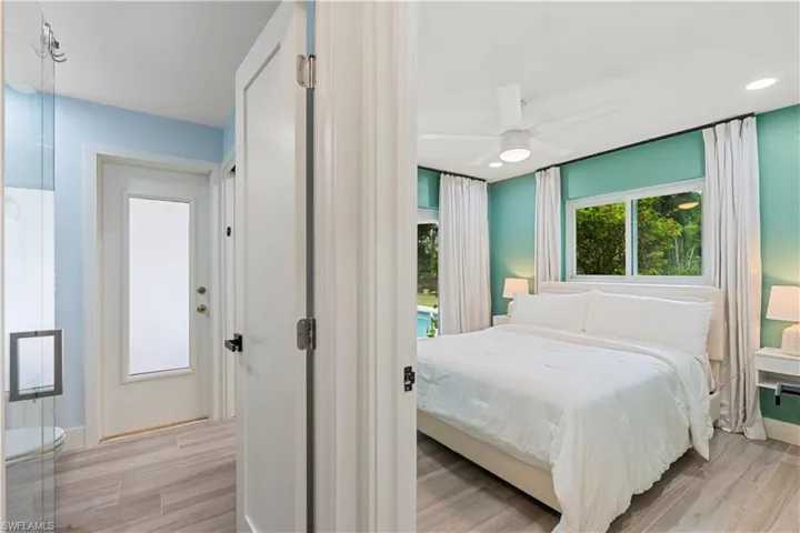 Bedroom with light wood finished floors, ceiling fan, and access to outside