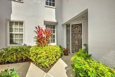 Entrance to property with stucco siding